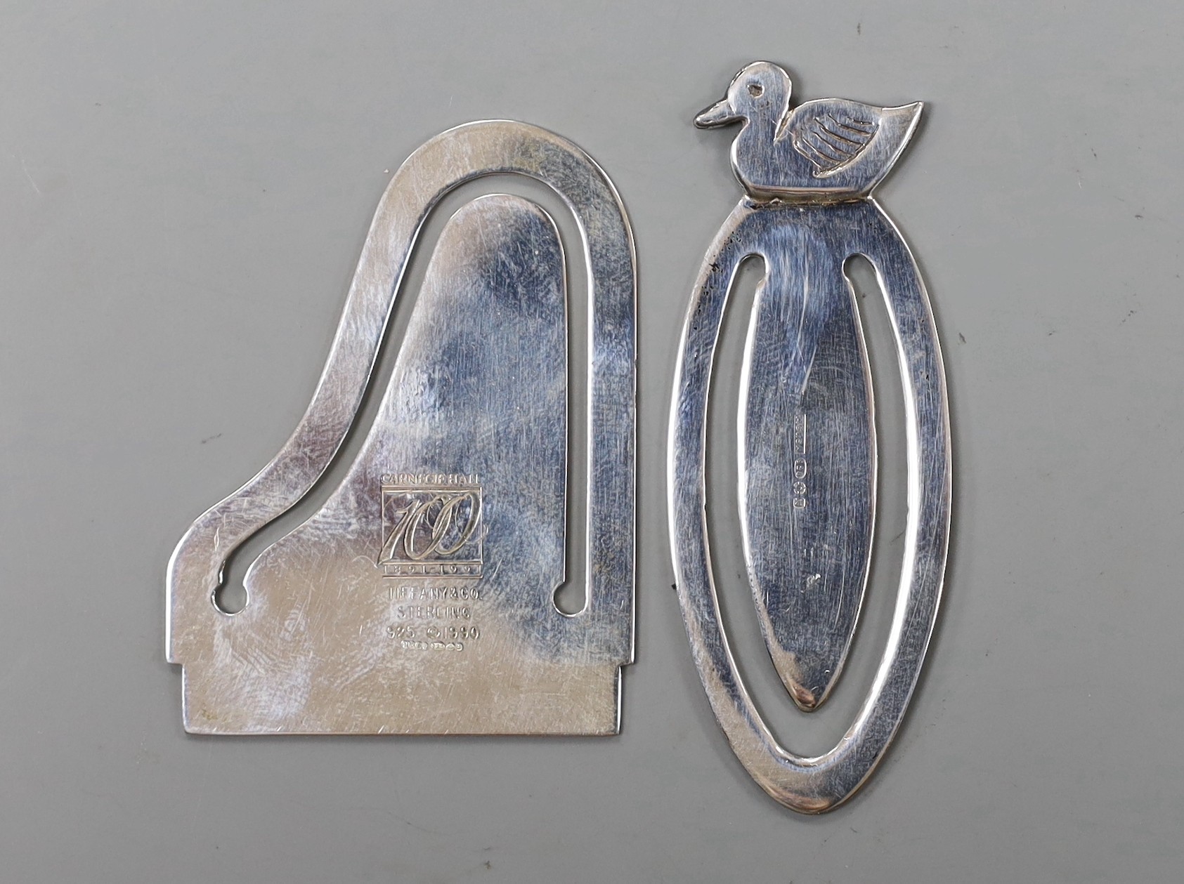 A modern Tiffany & Co 925 sterling commemorative bookmark, modelled as a grand piano and engraved ' Carnegie Hall 100 1891-1991, 47mm, with pouch and box and one other modern silver bookmark.